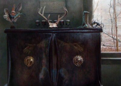 A painting of a wooden cabinet if front of a partial window revealing a winter landscape. The cabinet has two doors with ornate circular pull-knobs centered in the middle of each door. A reflection of a human figure with outreached arms is centered between the doors. On the top of the cabinet lies a glass containing feathers, a candelstick with a melted green candle reaching down to the cabinet top, a small statue of a dragon, a six-candle candelabra is centered at the rear of the cabinet top, and centered in the front is a silver 8-point deer antler rack. On the wall behind the cabinet is a vintage picture calendar. The painting is painted in hues of brown and green with the snowy outdoors providing a foggy white cast that highlights the items on the cabinet.