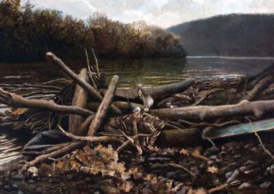 Painting of piled-up driftwood laying on a rocky river shore. A calm river recedes into the hills in the background on an overcast day.