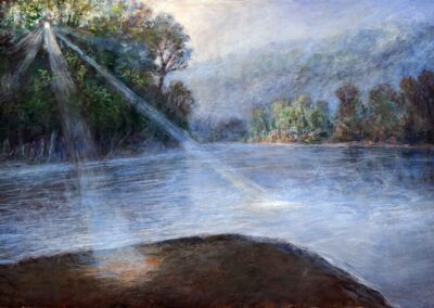 Bright blue river with sunlight streaming through the shoreline trees and hitting the water and the ground from where the artist paints.