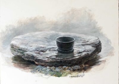 small cup sitting on rock in river.