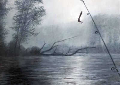 Fishing rod with fly at angle over river in the morning mist with a fallen tree laying on the river